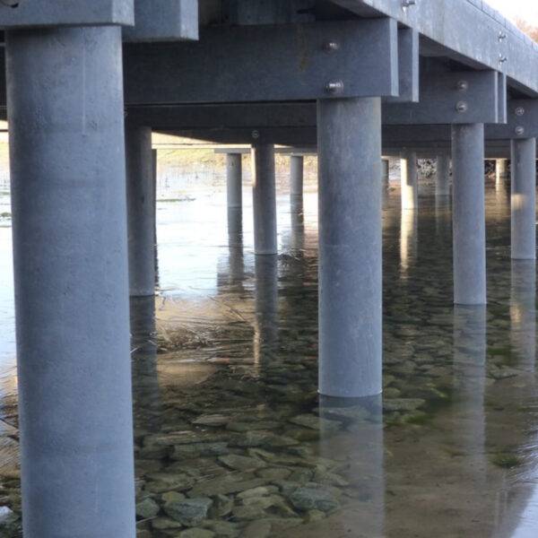 Grey Recycled Plastic Piles support a jetty over a marine environment